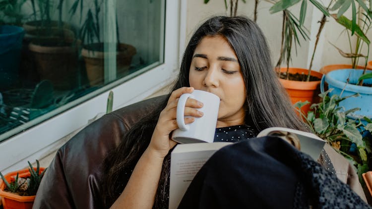 Woman Drinking In White Cup 