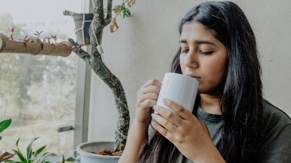 person practicing a healthy coping mechanism like meditation or drinking herbal tea - best way to get off methadone