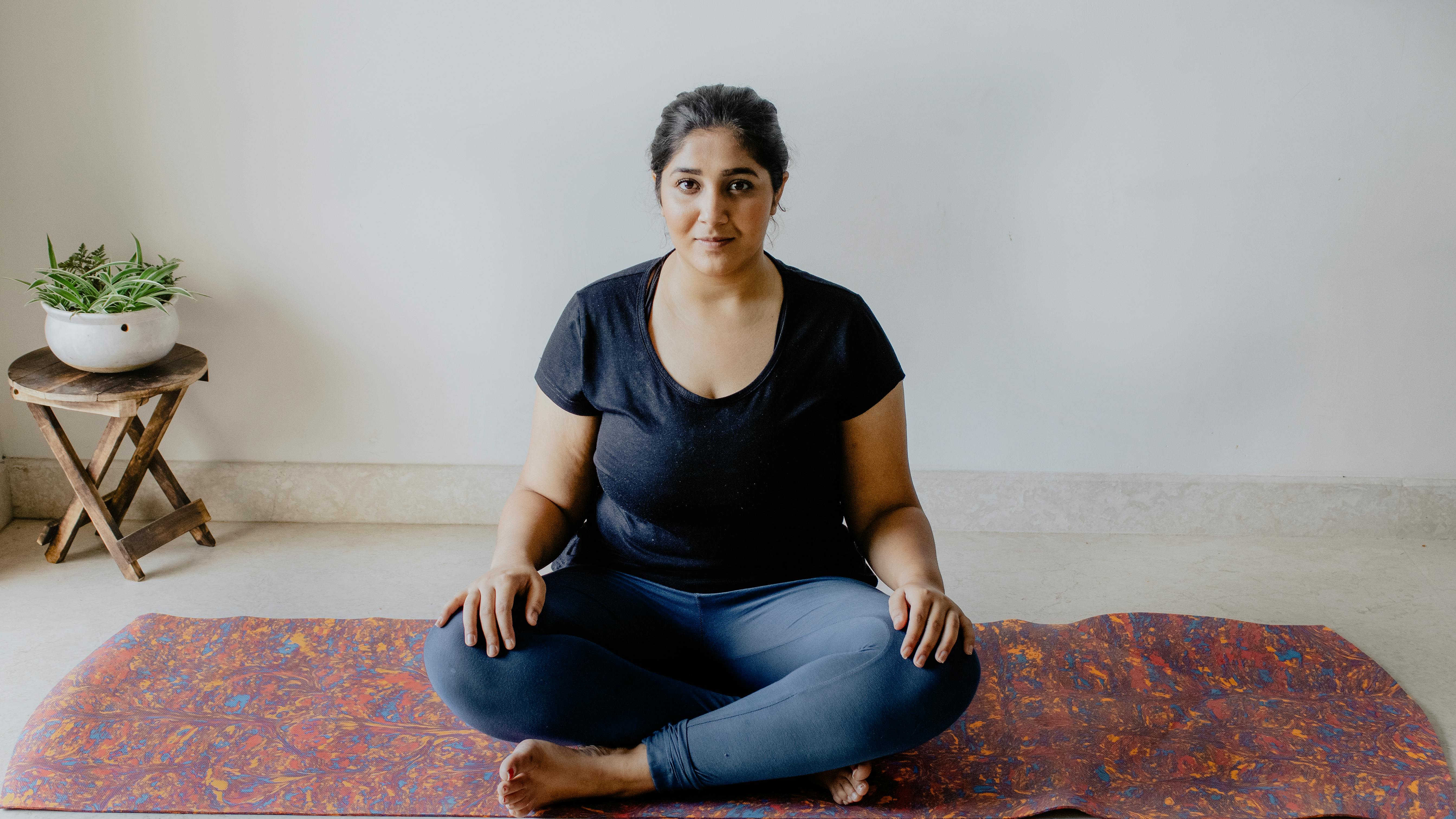 A Woman Sitting On The Yoga Mat · Free Stock Photo