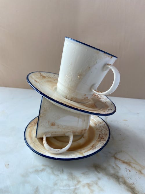 Stack of Dirty Coffee Cups on a Dirty Table