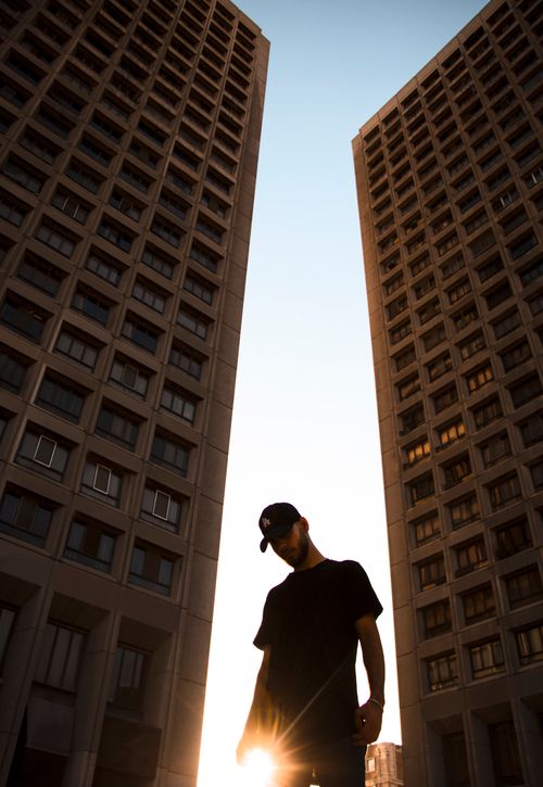 Free Dramatic silhouette of a man between two tall buildings in Tehran during sunset. Stock Photo
