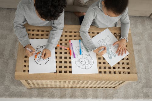 Unrecognizable black children coloring pictures