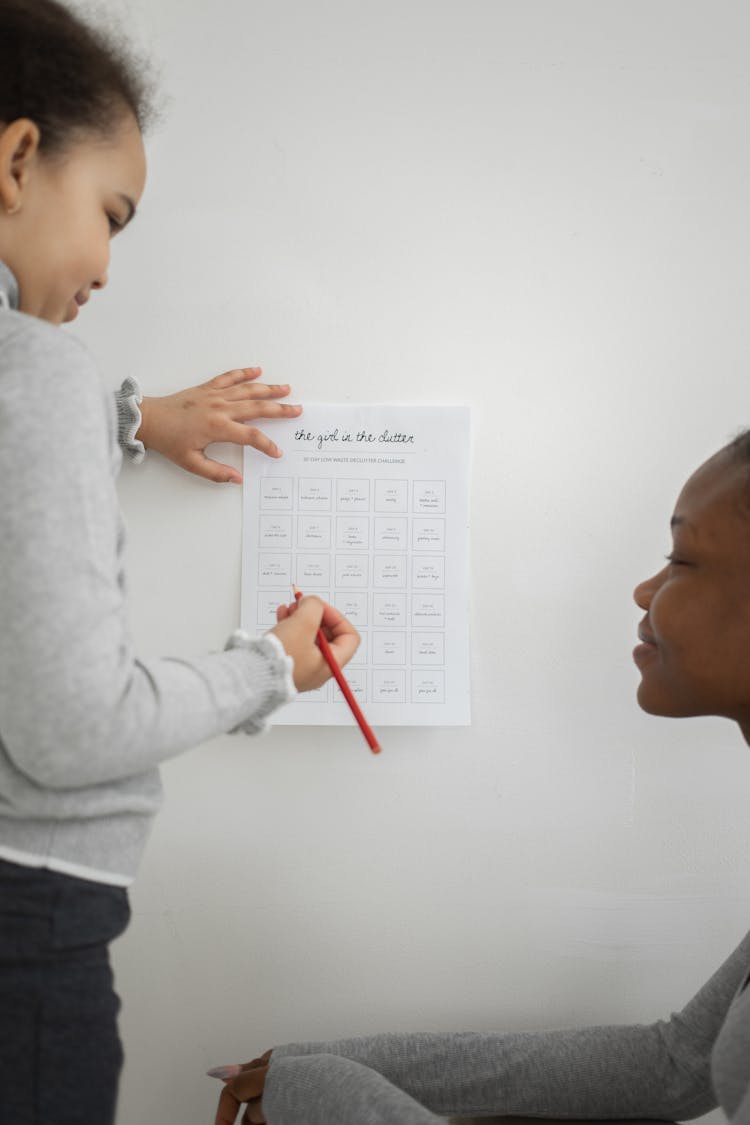 Black Woman And Kid With Paper