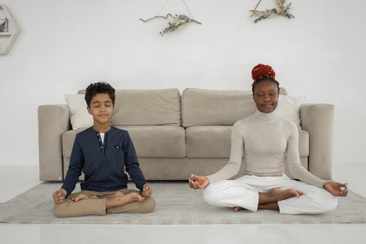 Woman And Little Boy Meditating