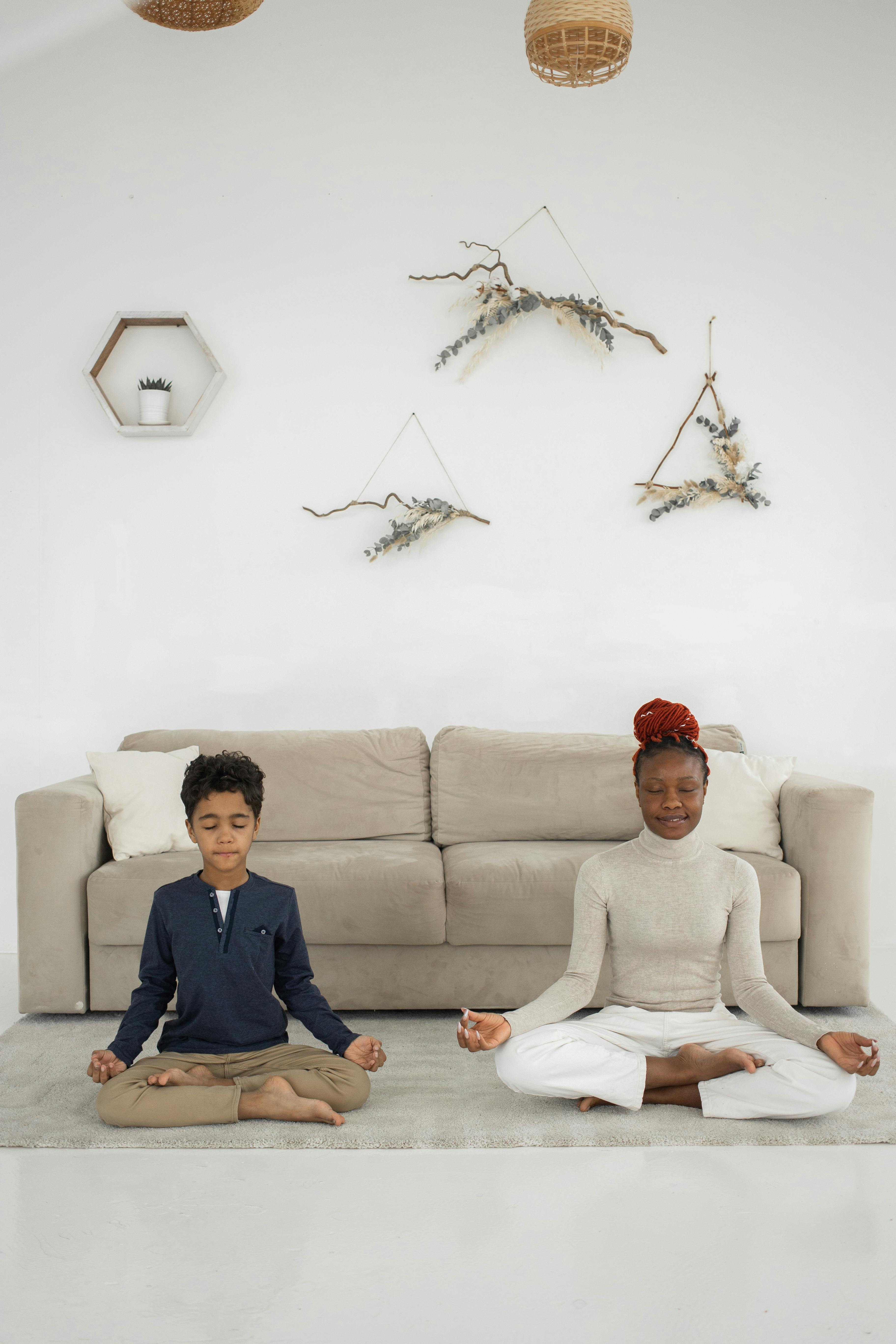 woman and boy sitting and meditating