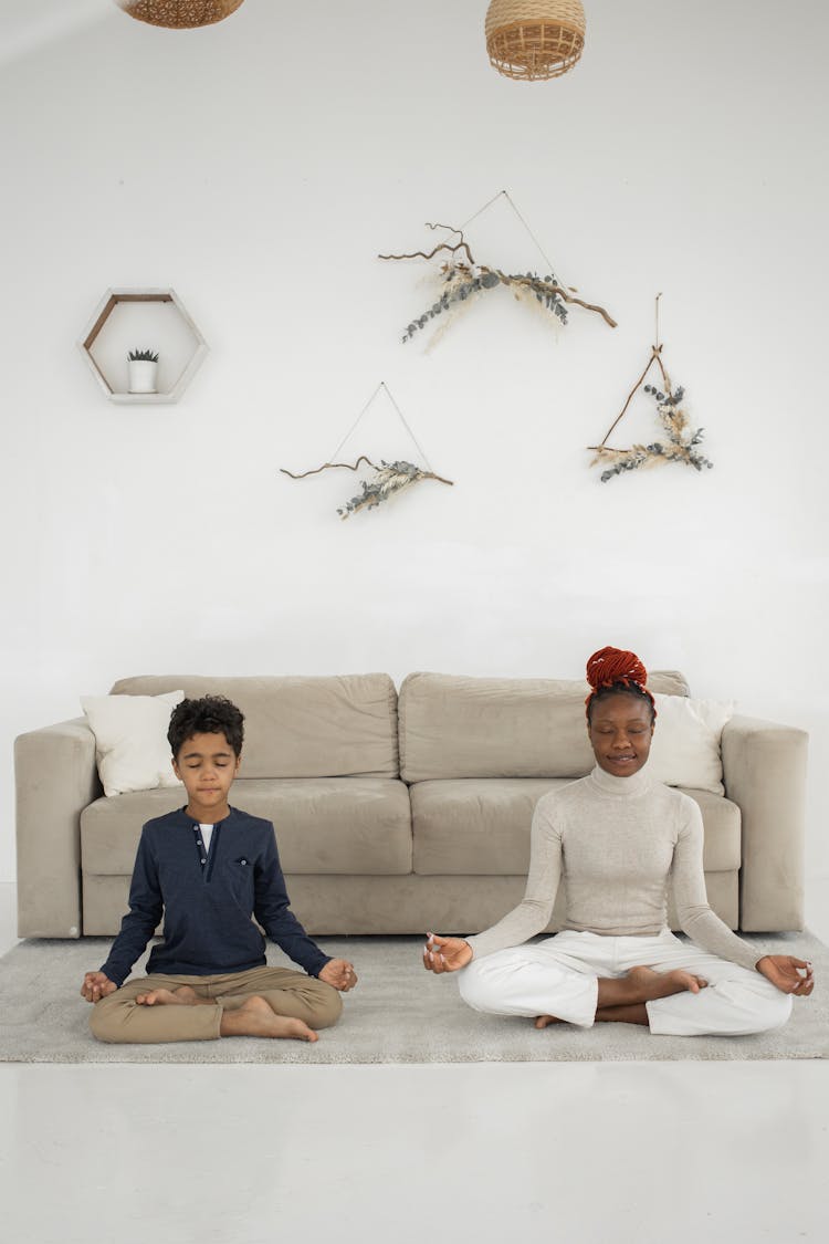 Woman And Boy Sitting And Meditating