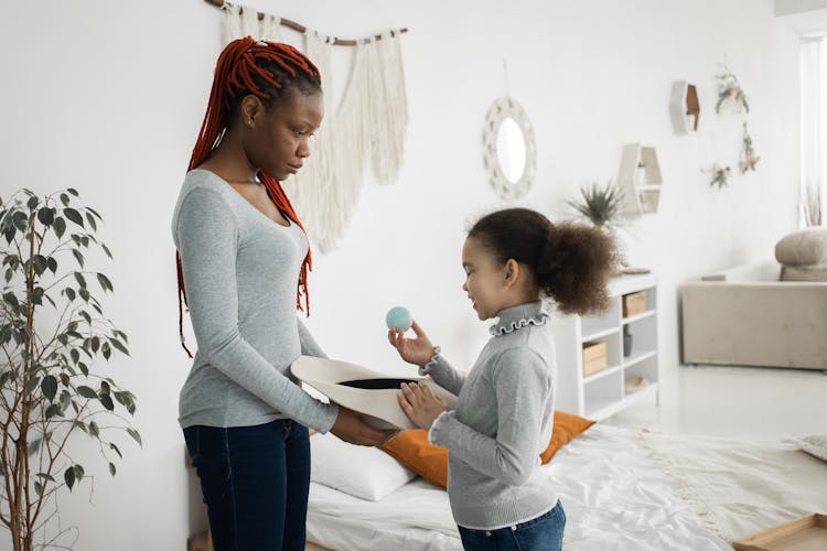 Black Woman With Daughter In Bedroom