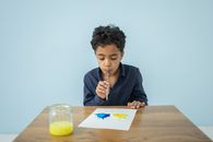 Black boy drawing with watercolor