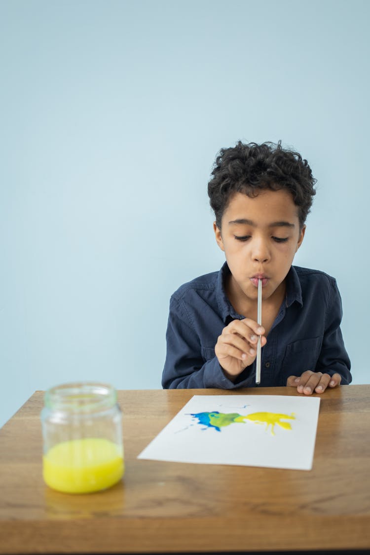 Little Child With Watercolor And Straw