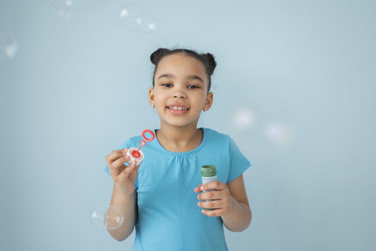 Happy Child With Soap Bubbles