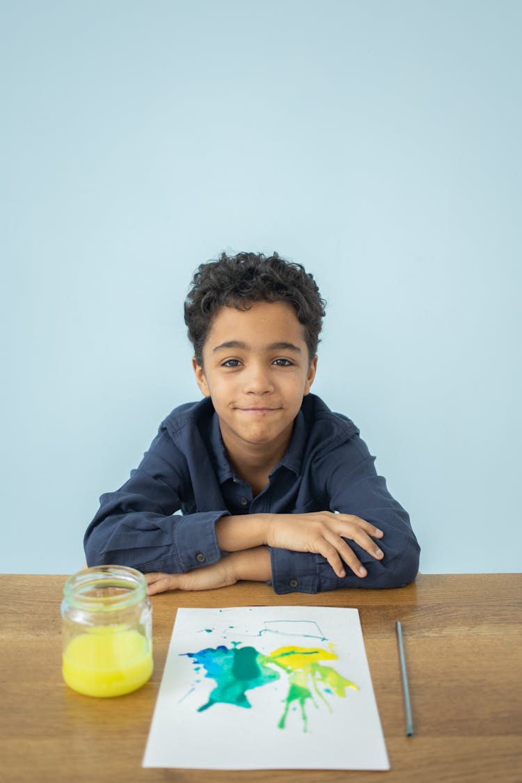 Happy Kid With Drawing On Table