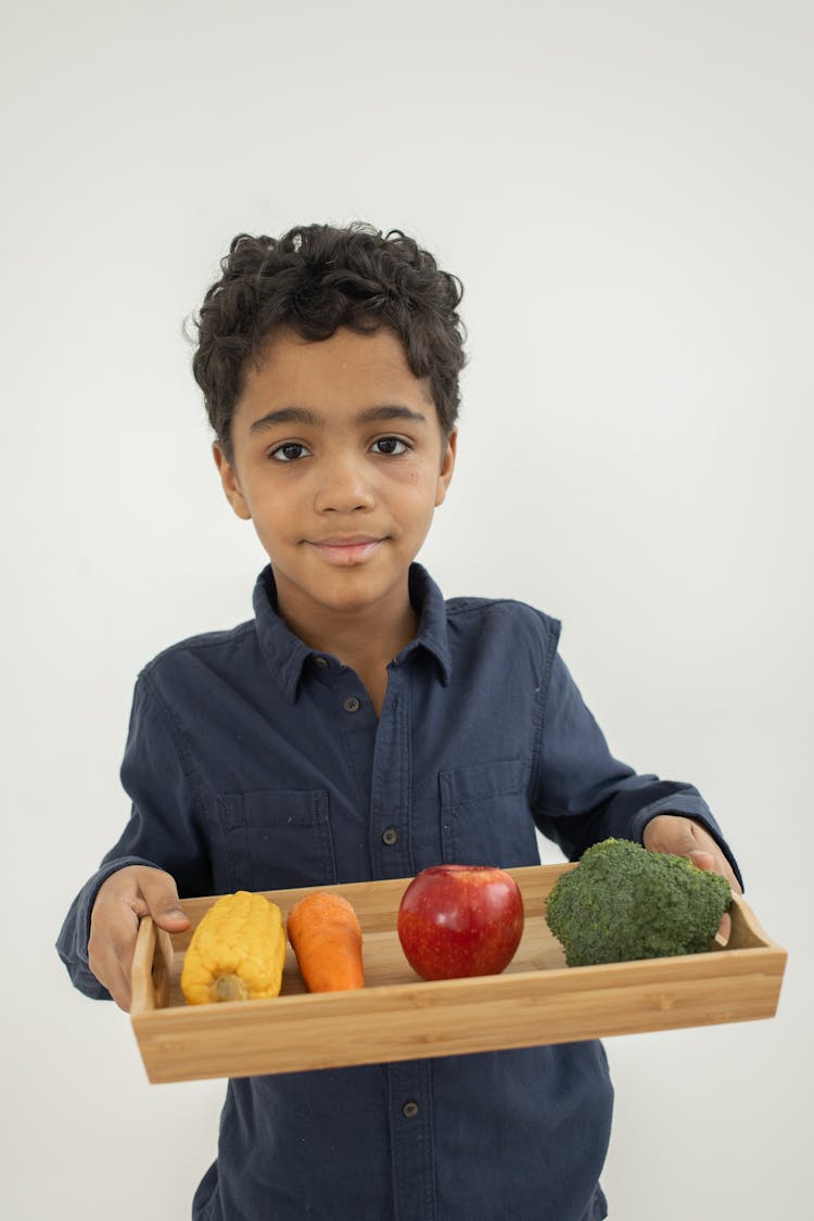 Smiling Black Kid Demonstrating Tray With Colorful Healthy Vegetables