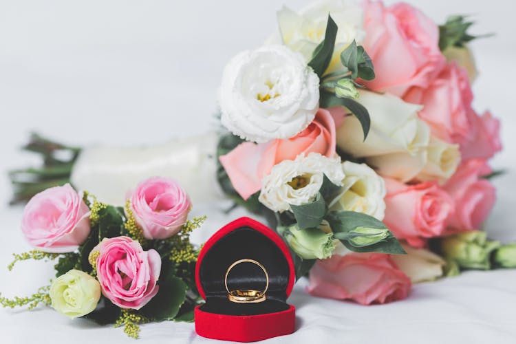 Bouquet With Roses And A Engagement Ring In A Red Box