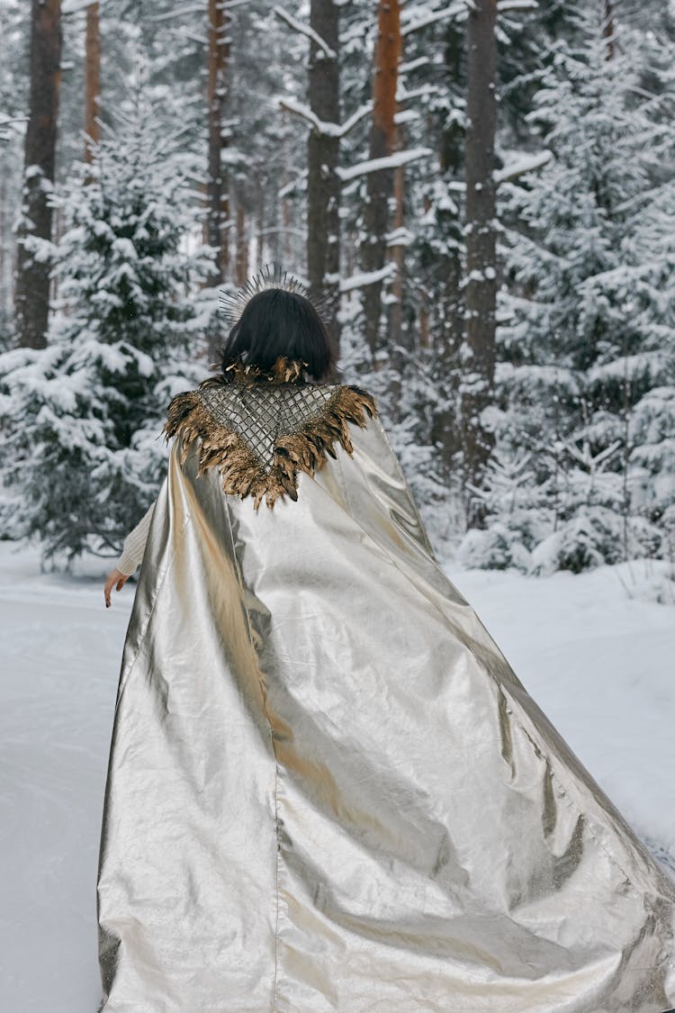 Woman Wearing A Cape Walking Away