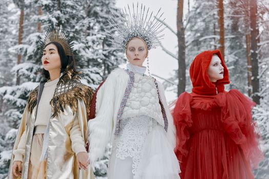Three Women Wearing Costumes Standing Side by Side