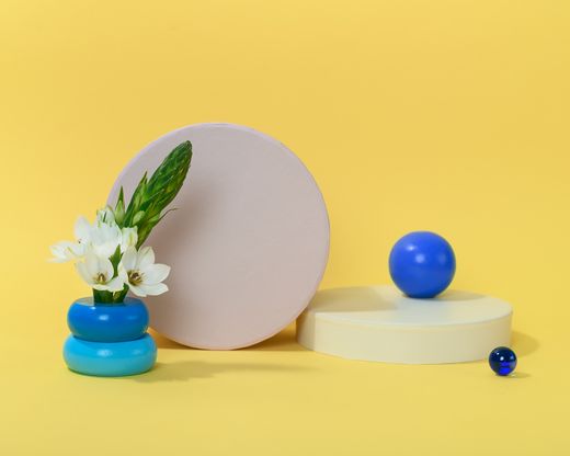 White flowers beside blue objects — Photo by Daria Liudnaya on Pexels