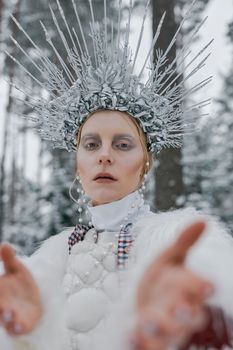 Striking winter portrait featuring a woman adorned with an elaborate crown, embodying elegance and fashion.