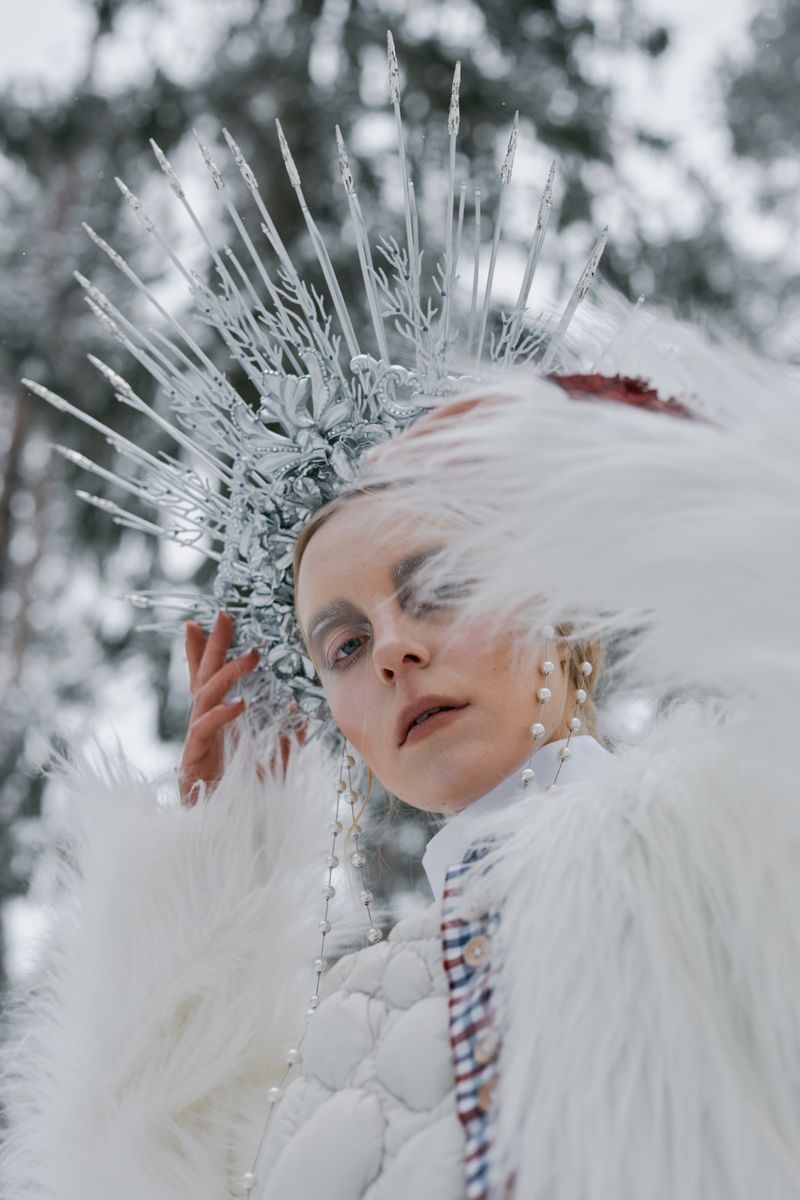 Woman wearing headdress and fur coat in the snow