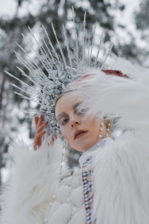 Free Woman wearing intricate headdress and fur coat capturing a fairytale aura outdoors. Stock Photo