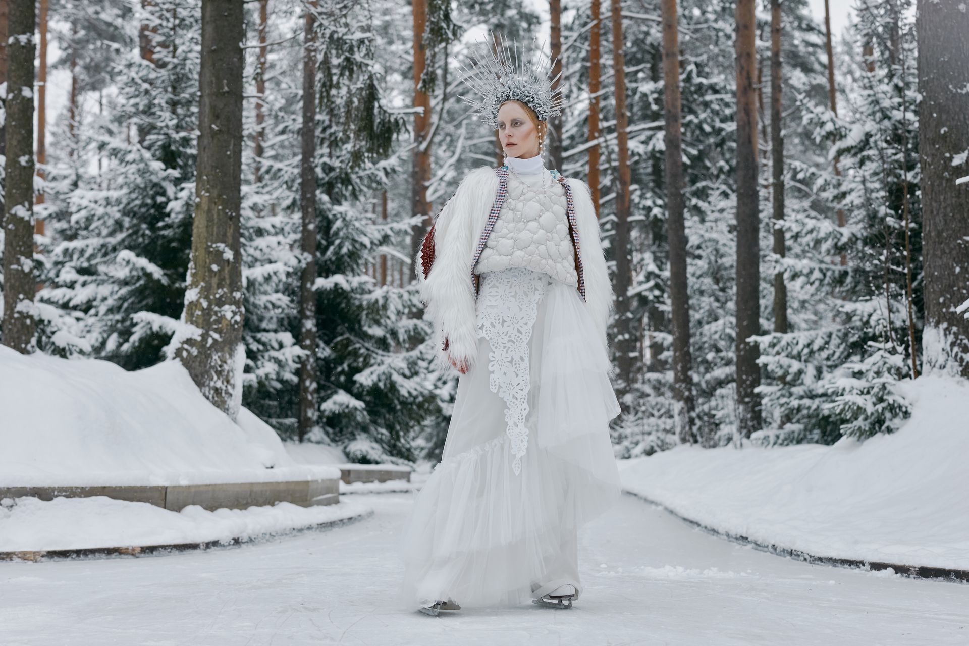A Woman in White Dress with a Crown Wearing Ice Skates