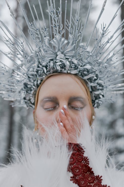 Woman Wearing a Headdress With Hand on Face