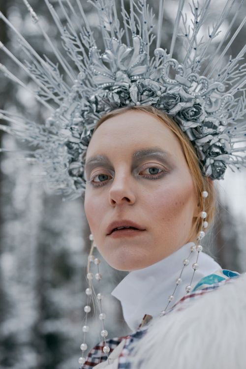 Free A mystical snow queen in a silver crown in a winter setting. Stock Photo