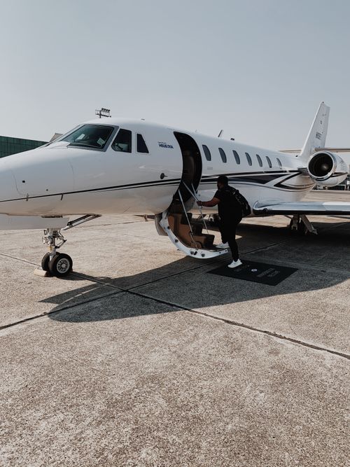 Free Person boarding a private jet at an airport in Guatemala City on a sunny day. Stock Photo
