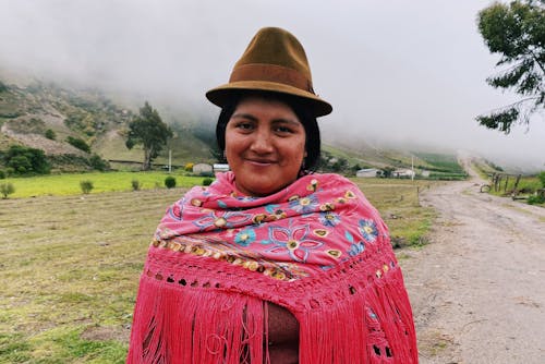 Smiling Woman in a Hat and a Shawl