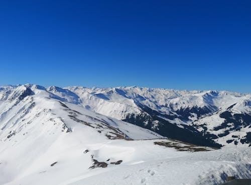 Snow-Covered Mountain Under Blue Sky