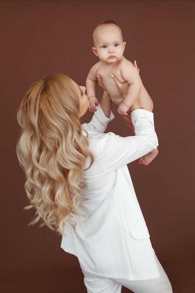 Woman Lifting A Baby