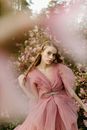 Woman in Pink Dress Standing Near Pink Flower