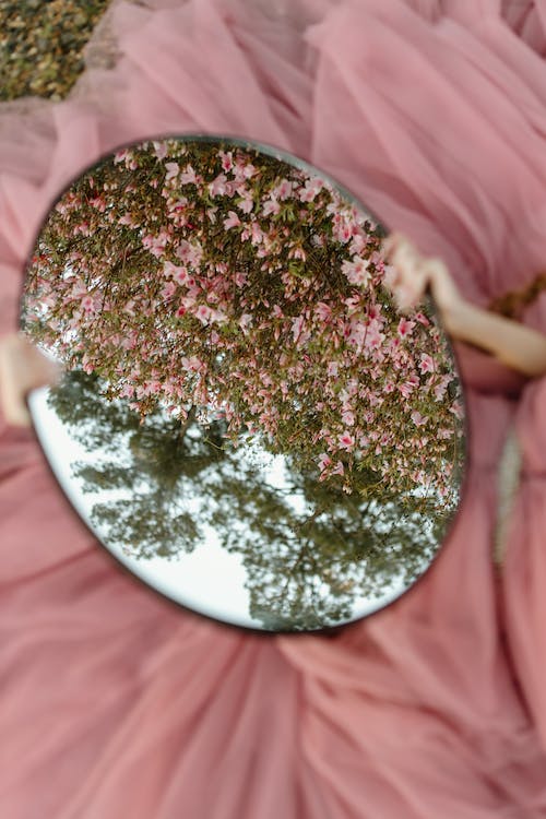 Free Person Holding an Oval Mirror Stock Photo