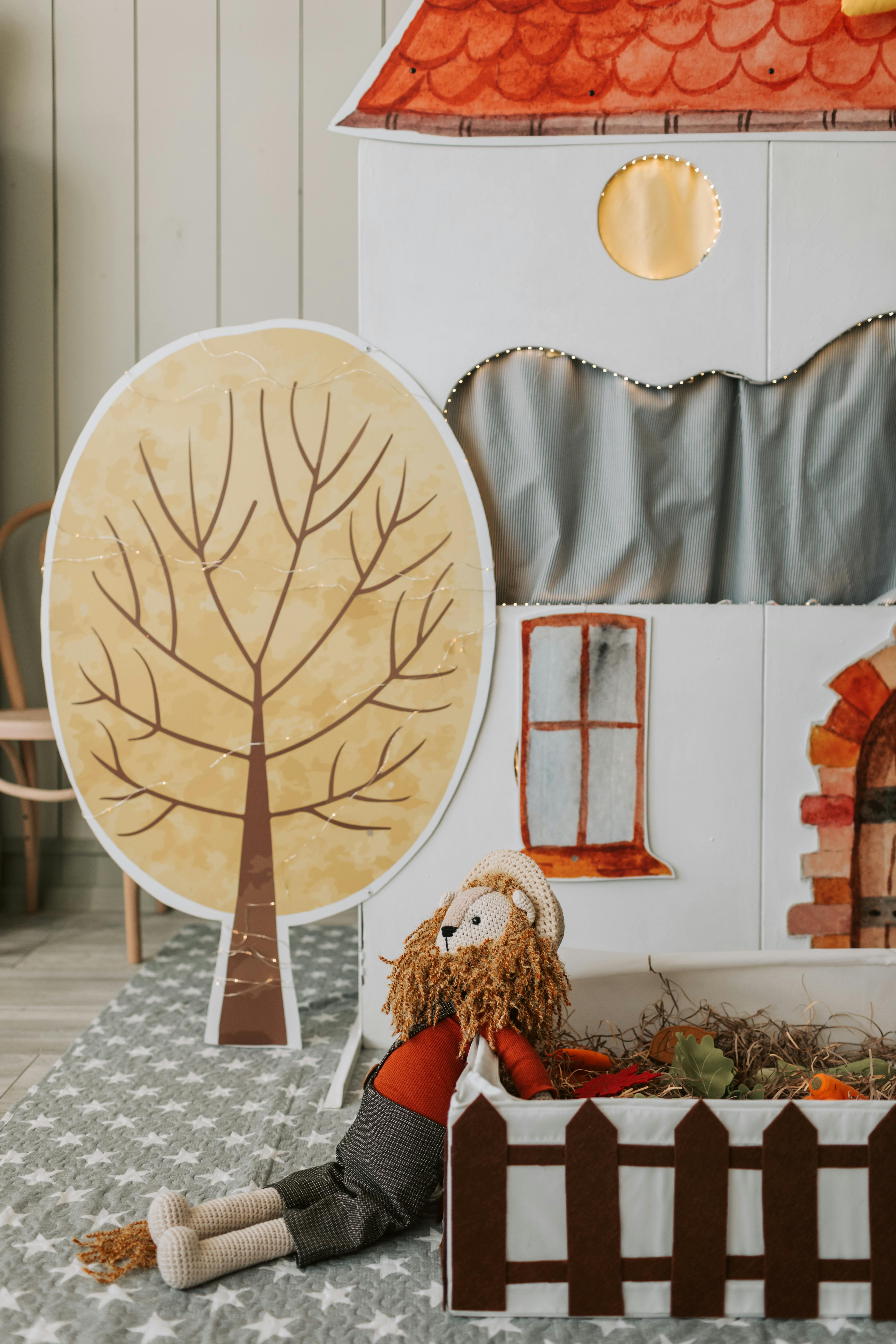 Whimsical puppet theater setup with a charming stuffed toy and cozy fall decor.
