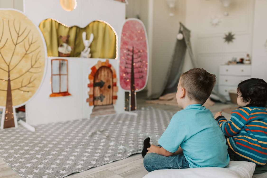 Free Two Boys Watching a Puppet Show Stock Photo