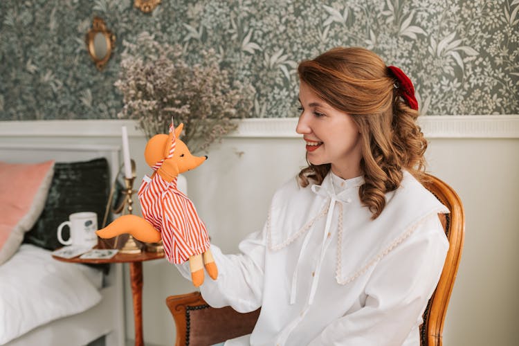 Woman Looking At A Hand Puppet