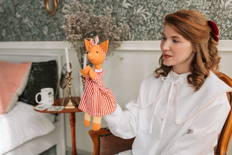 Woman Looking At A Puppet