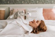 Woman Lying on the Bed with a Hand Puppet