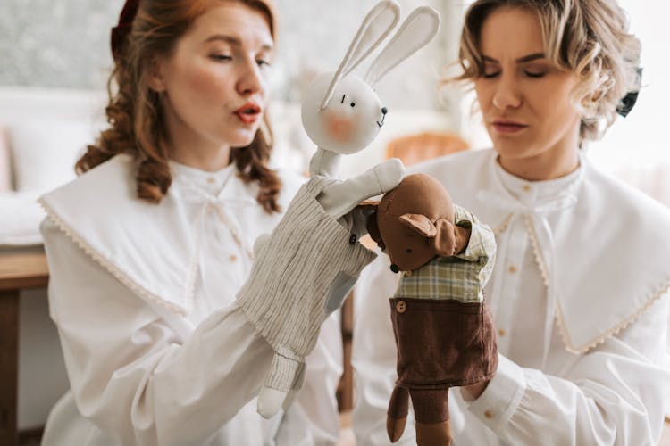 Two Women Holding Puppets