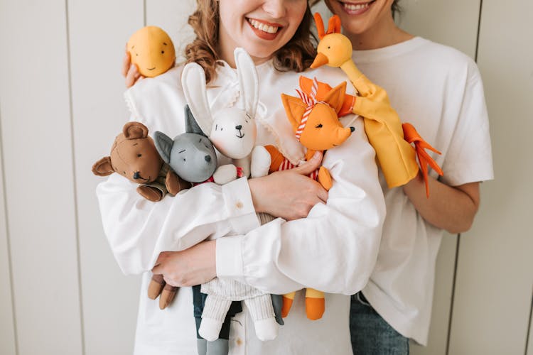 Women Carrying Dolls And Puppets