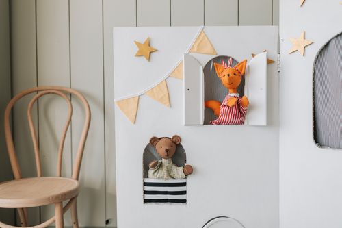 Free Adorable puppet theater setup featuring animal puppets indoors with neutral decor. Stock Photo