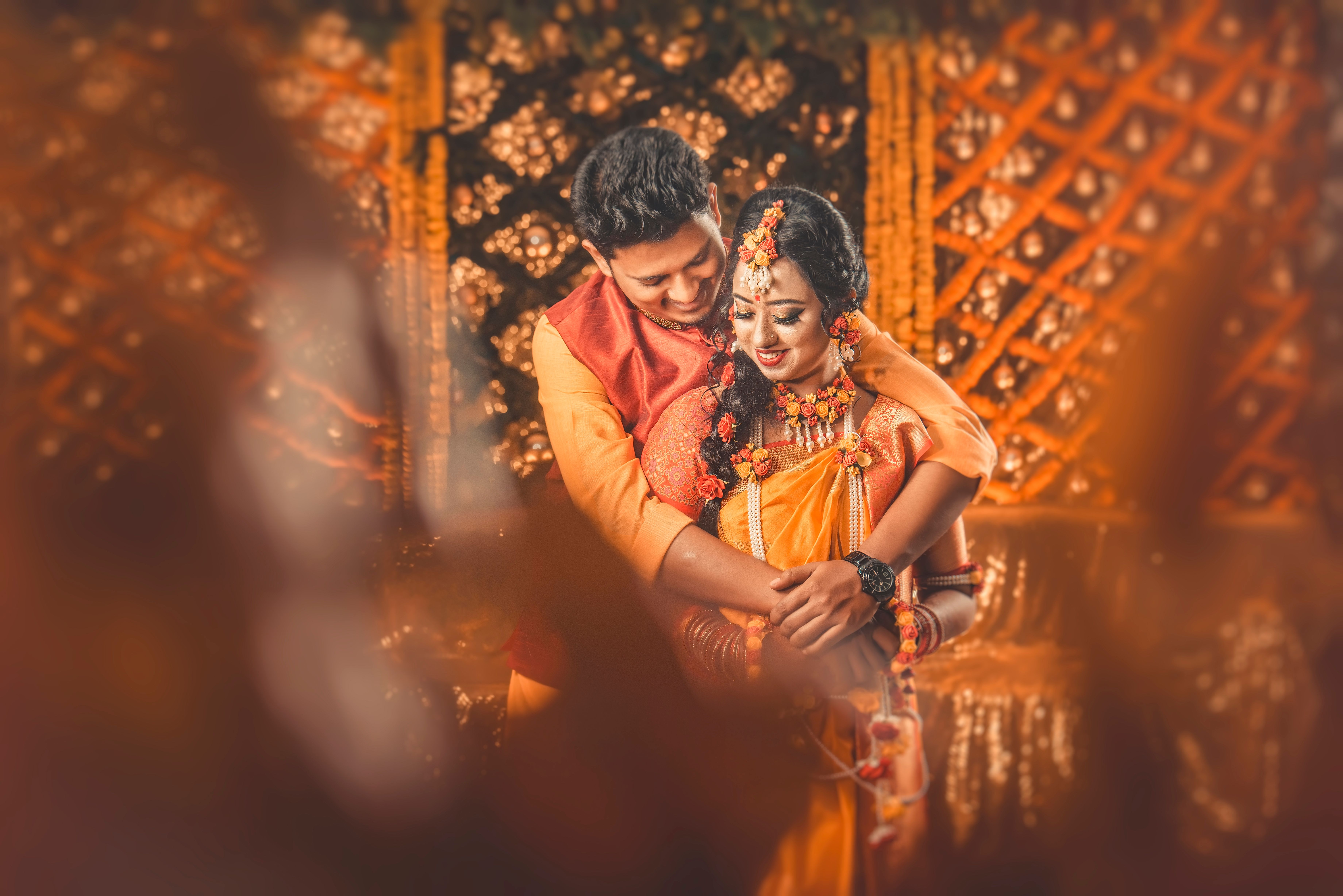 A loving couple in traditional attire sharing an intimate moment during their wedding in Bangladesh.