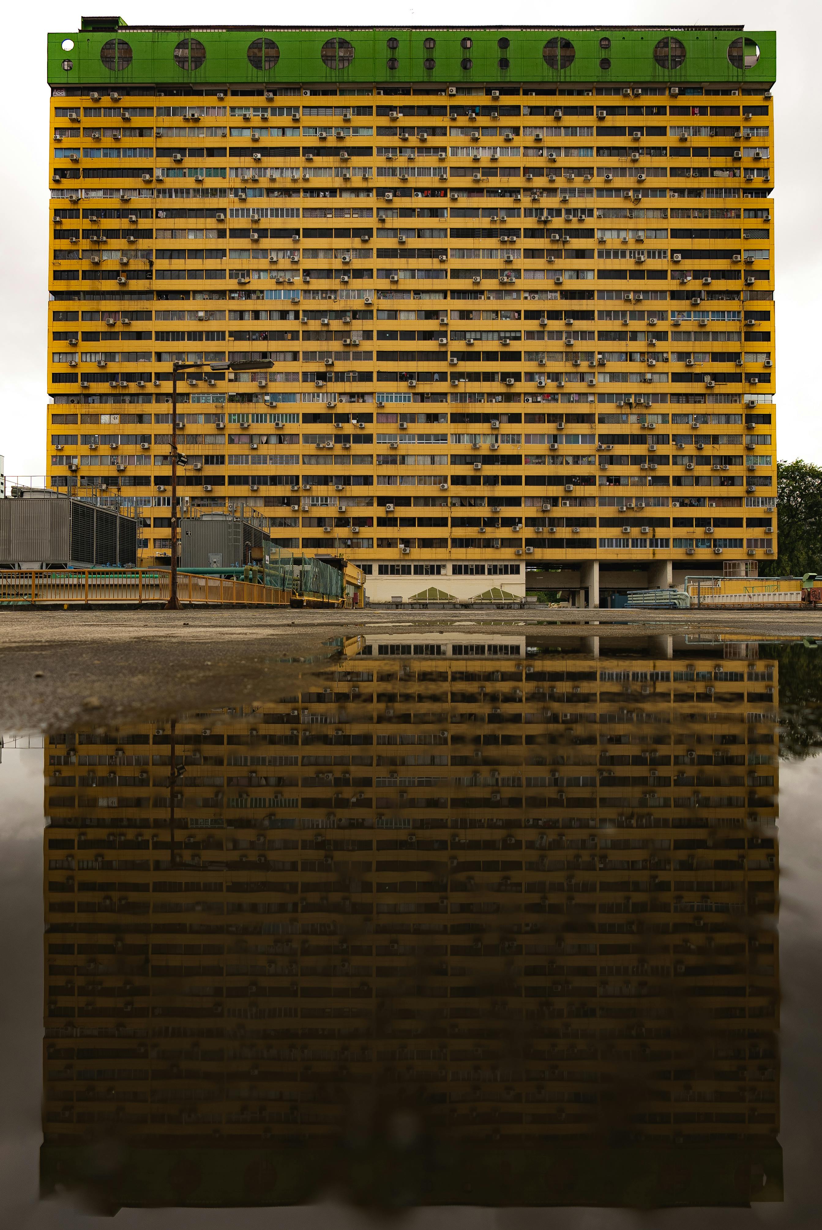Factory Building Reflecting in Puddle · Free Stock Photo