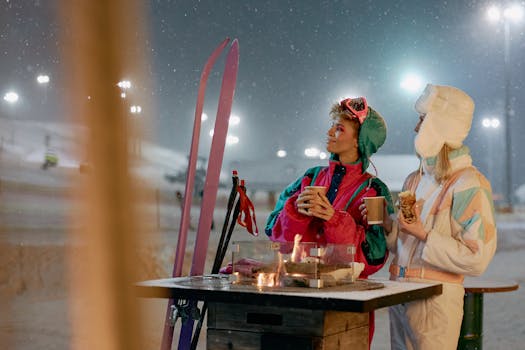 Women enjoying warm beverages by a fire outdoors on a snowy winter night