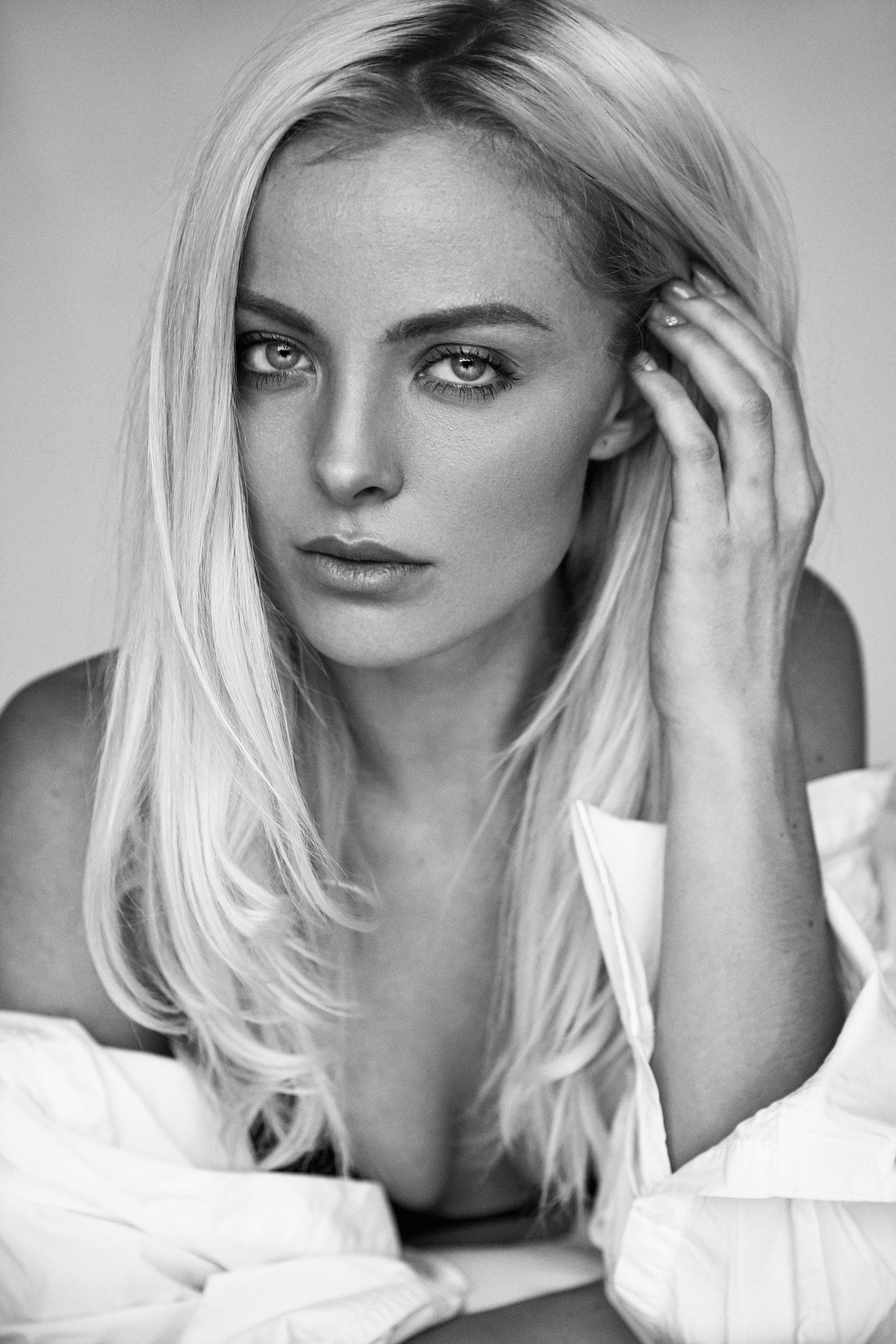 A Grayscale Photo of a Beautiful Woman with Her Hand on Her Hair · Free ...