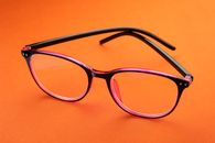 Black Framed Eyeglasses on Orange Textile