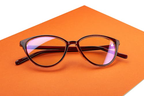 Black Framed Eyeglasses on Orange Background