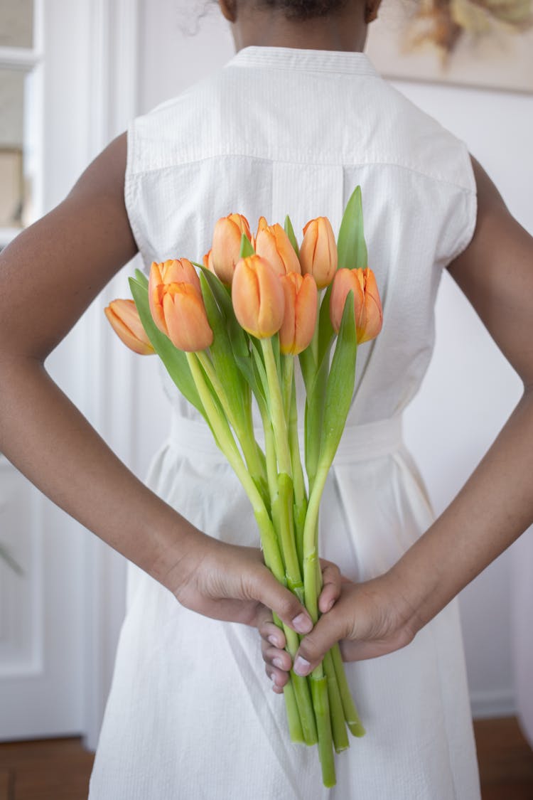 A Girl Holding A Bouquet Of Flowers