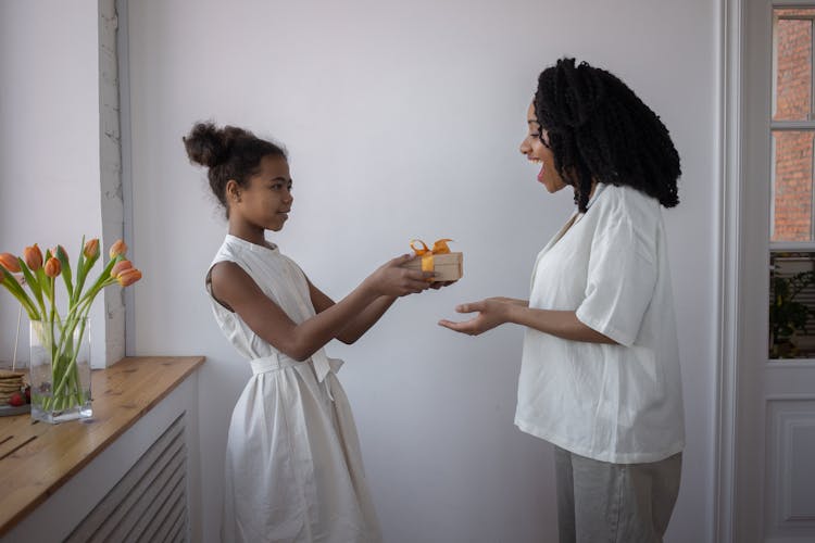 A Girl Giving Her Mother A Present For Mother's Day