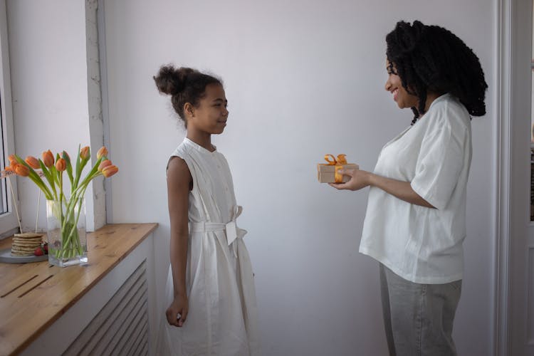 Woman Giving A Gift To Her Daughter