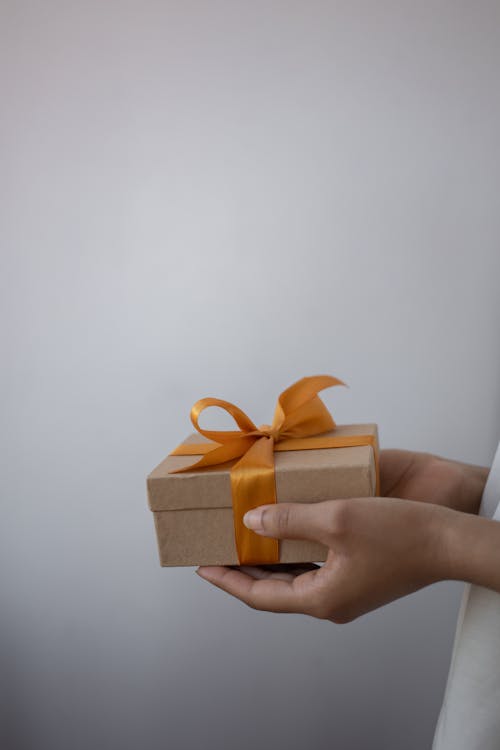 Close-Up Shot of a Person Holding a Gift Box